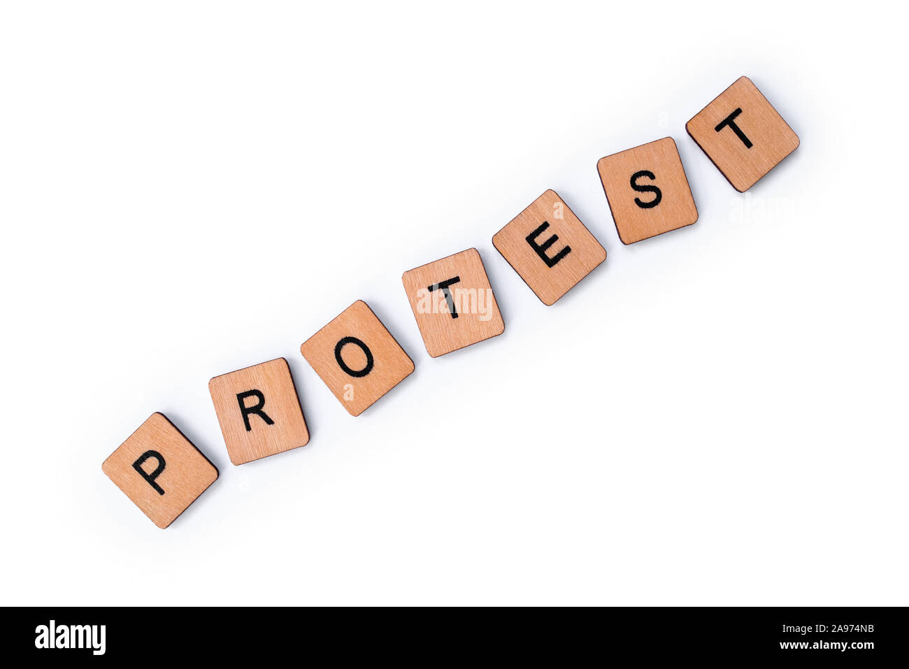 The word PROTEST, spelt with wooden letter tiles over a plain white background. Stock Photo