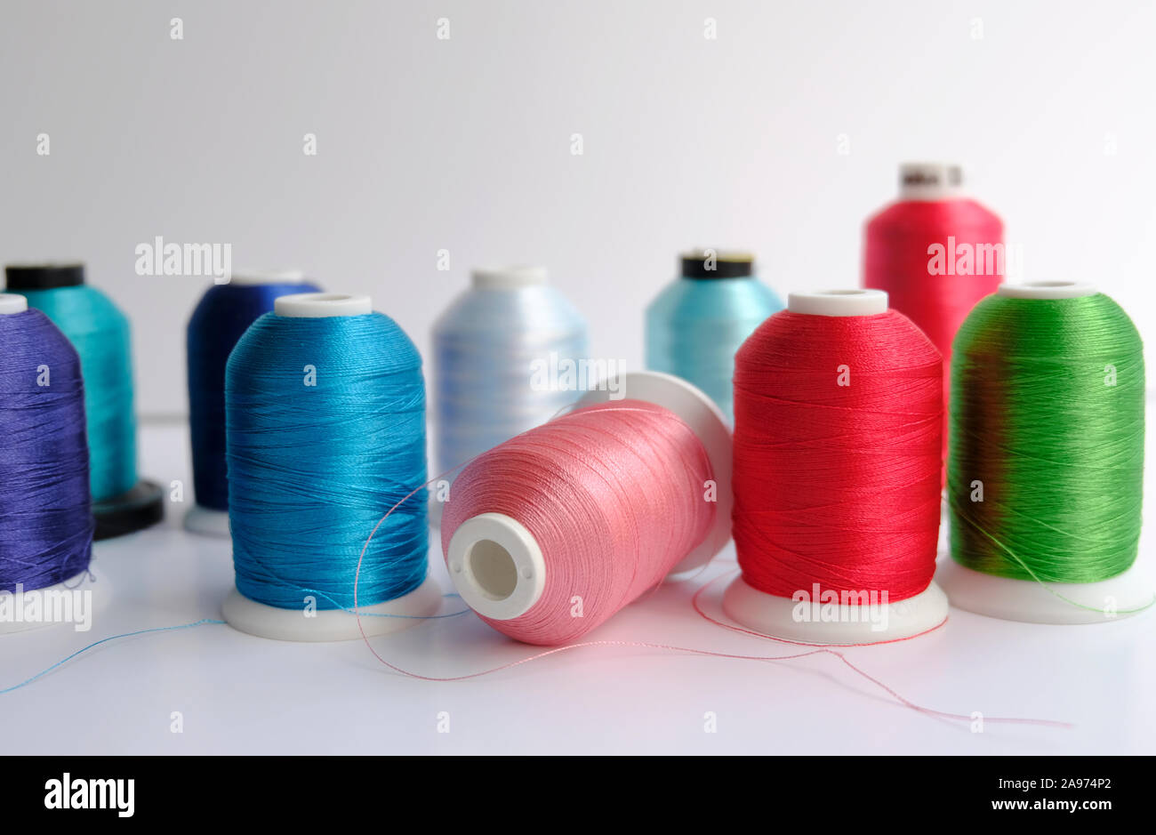 A collection of different coloured spools of domestic machine embroidery threads Stock Photo