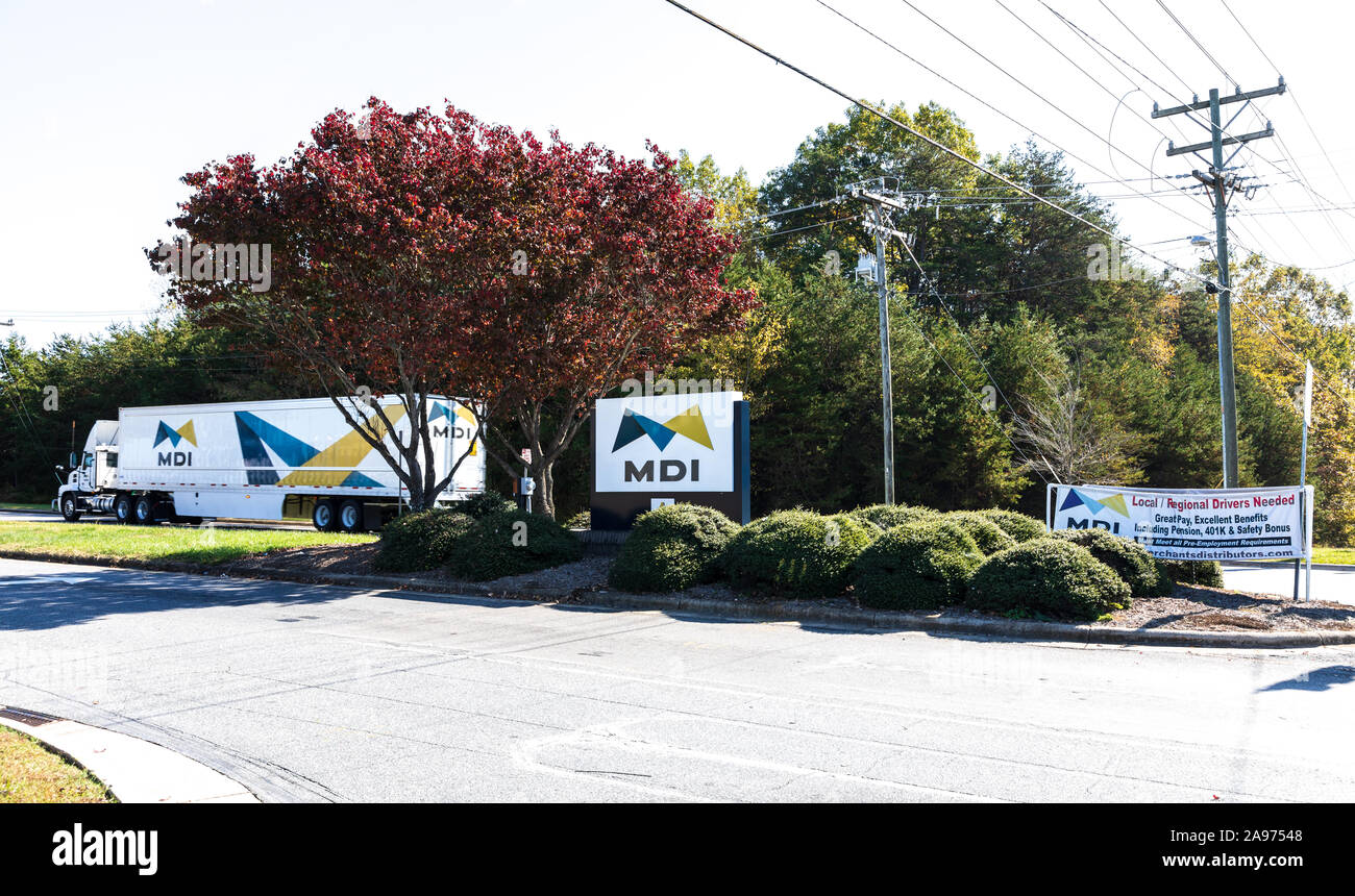 HICKORY, NC, USA-2 NOV 2019:  Merchants Distributors, Inc.truck, road sign, help wanted sign,  and decorative foliage.  MDI is a privately-owned food Stock Photo