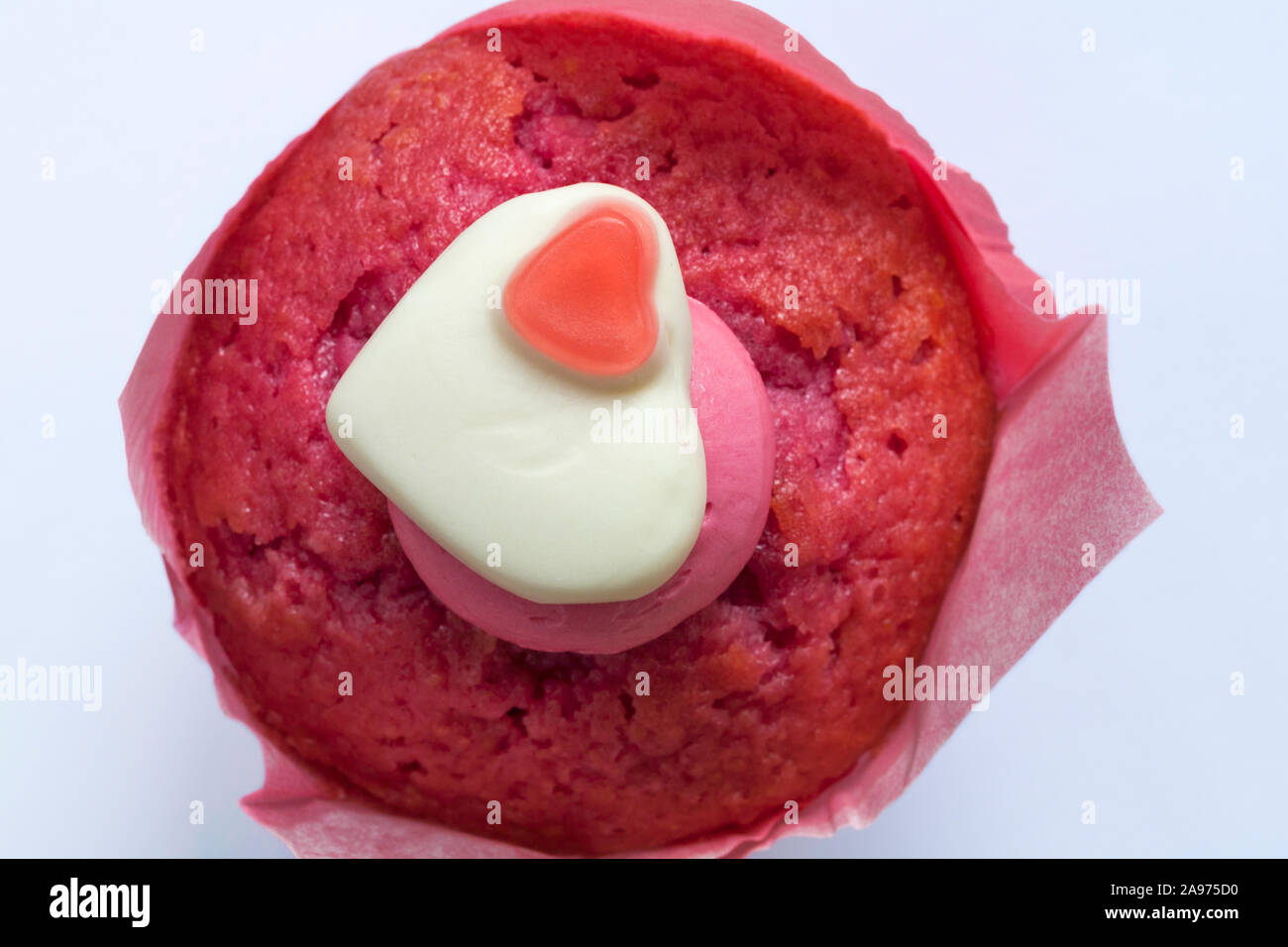 Percy Pig heart sweet muffin fresh from M&S in-store bakery set on white background Stock Photo