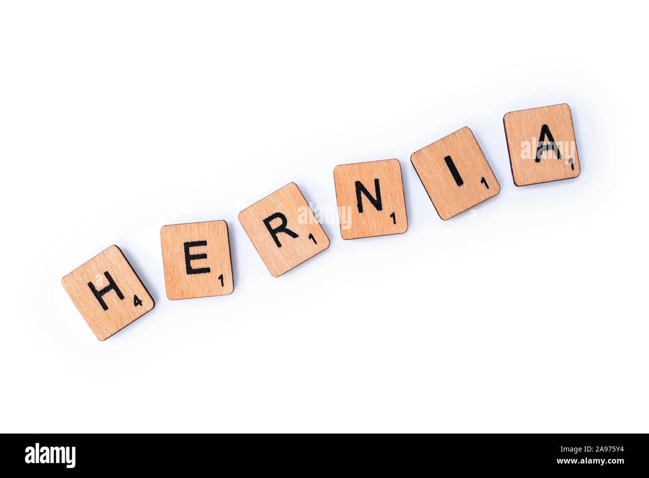 London, UK - July 8th 2019: The word HERNIA, spelt with wooden letter tiles over a white background. Stock Photo