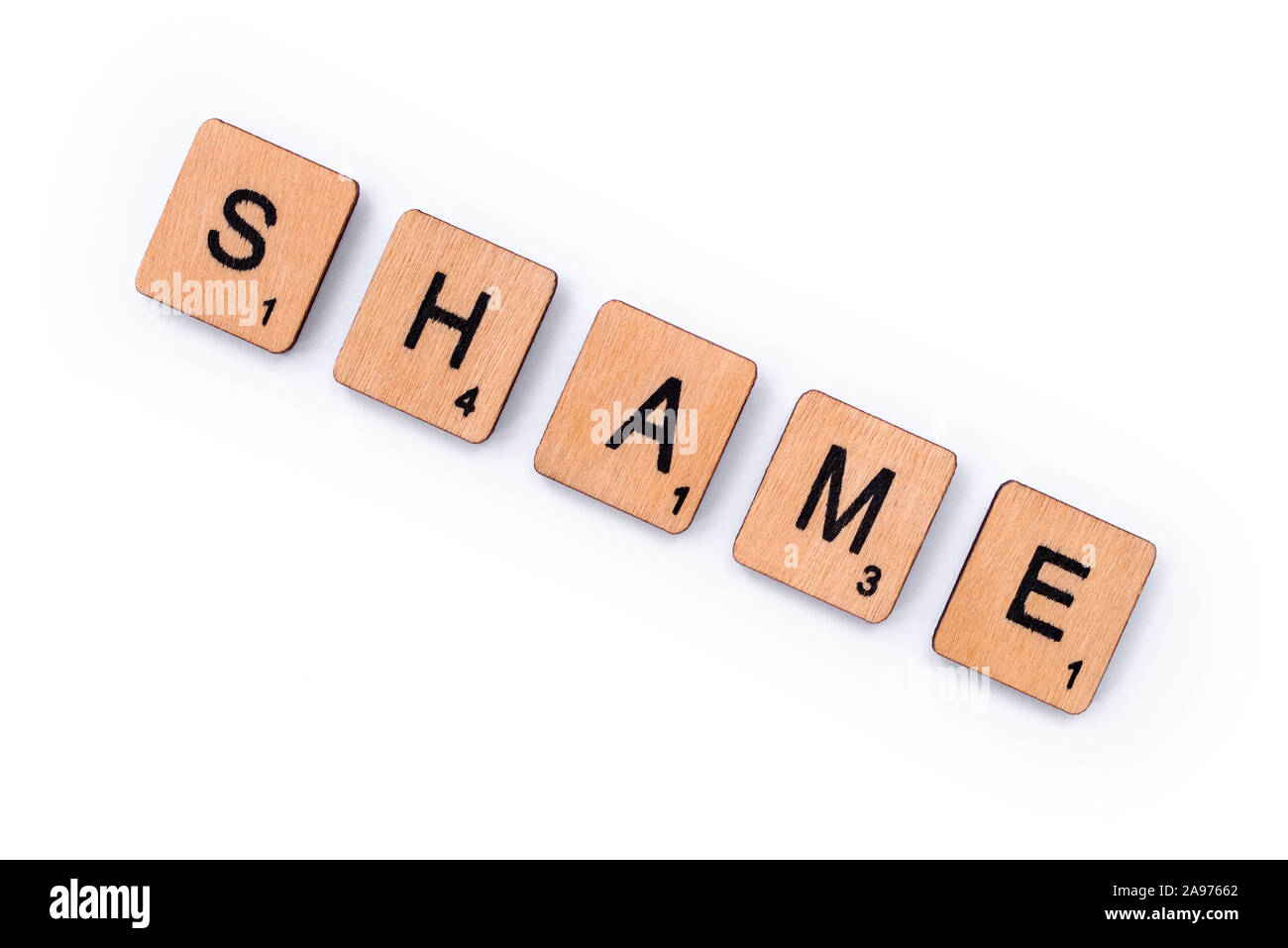 London, UK - July 8th 2019: The word SHAME, spelt with wooden letter tiles over a white background. Stock Photo