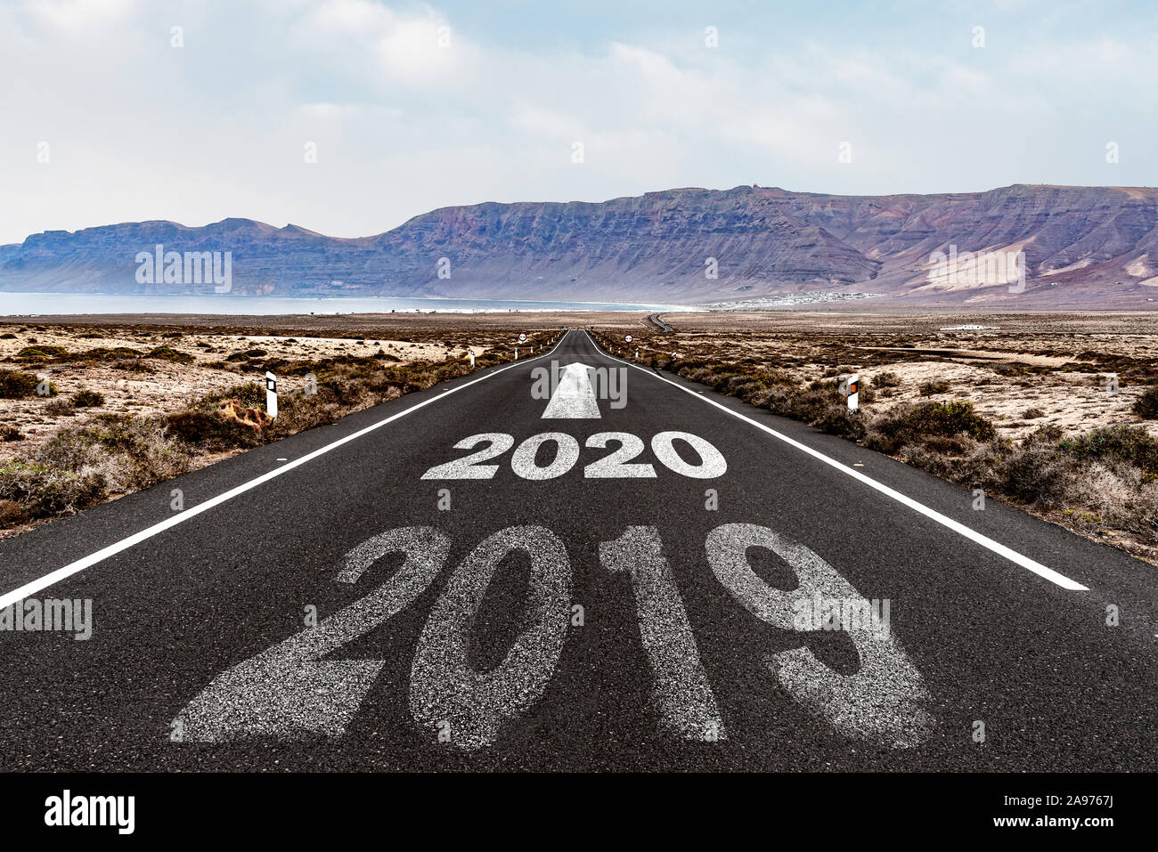 year 2020 with arrow pointing ahead on asphalt road, new year concept Stock Photo