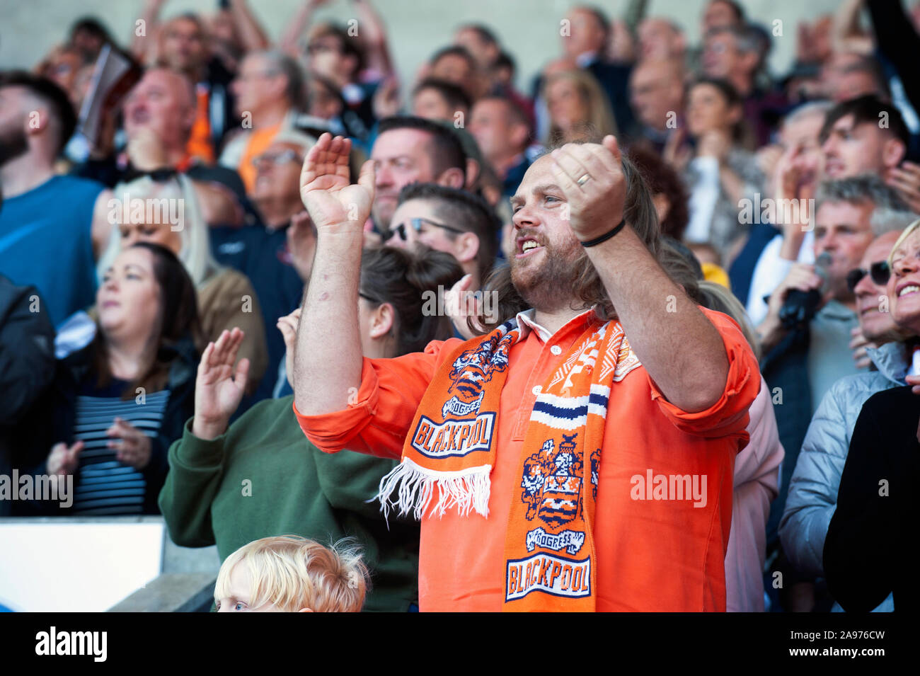 A man is watching a game of football at Blackpool Football Club Stock Photo