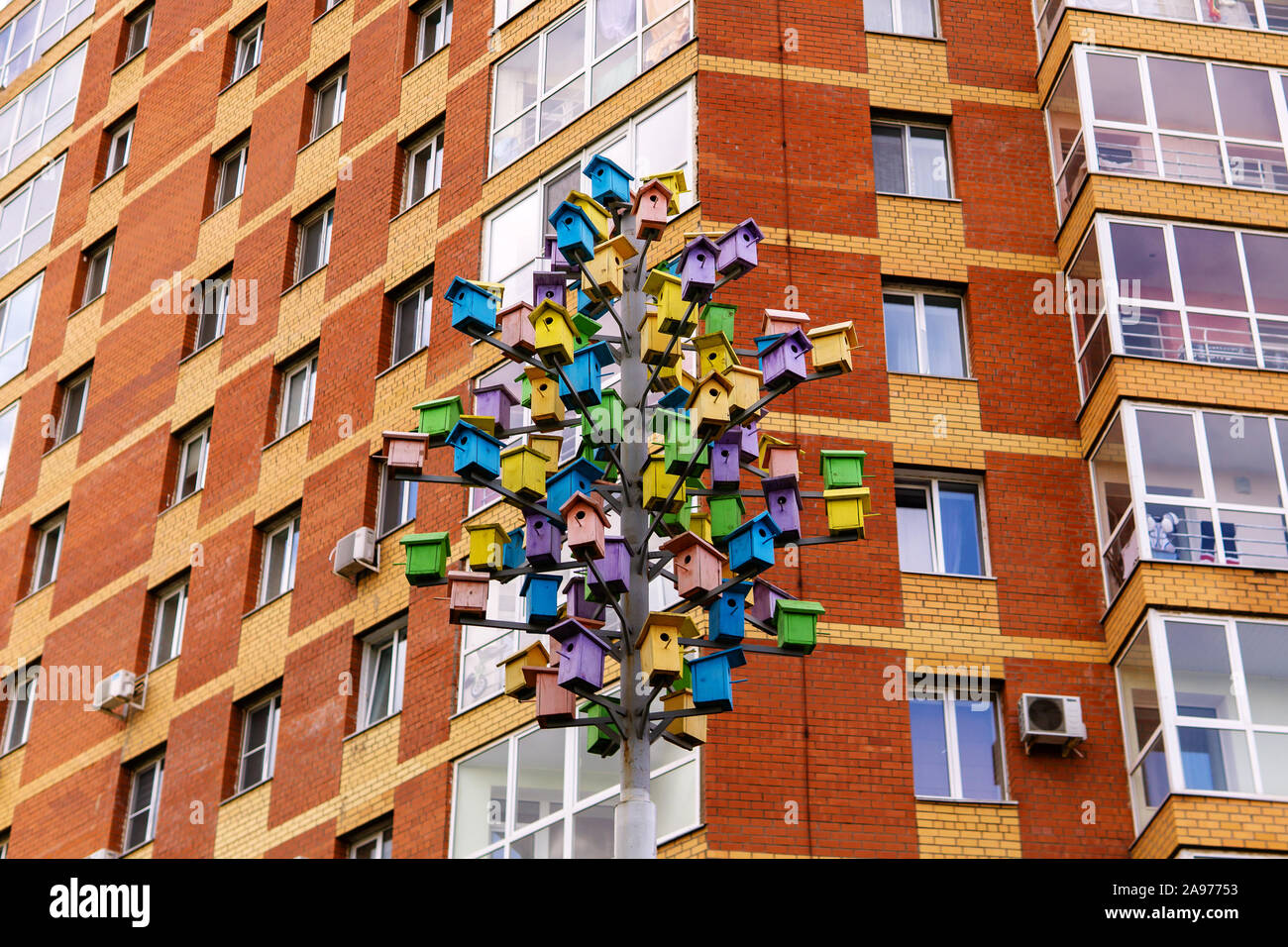 Perm, Russia - August 04, 2019: art object tree of birdhouses on the background wall of an apartment building Stock Photo
