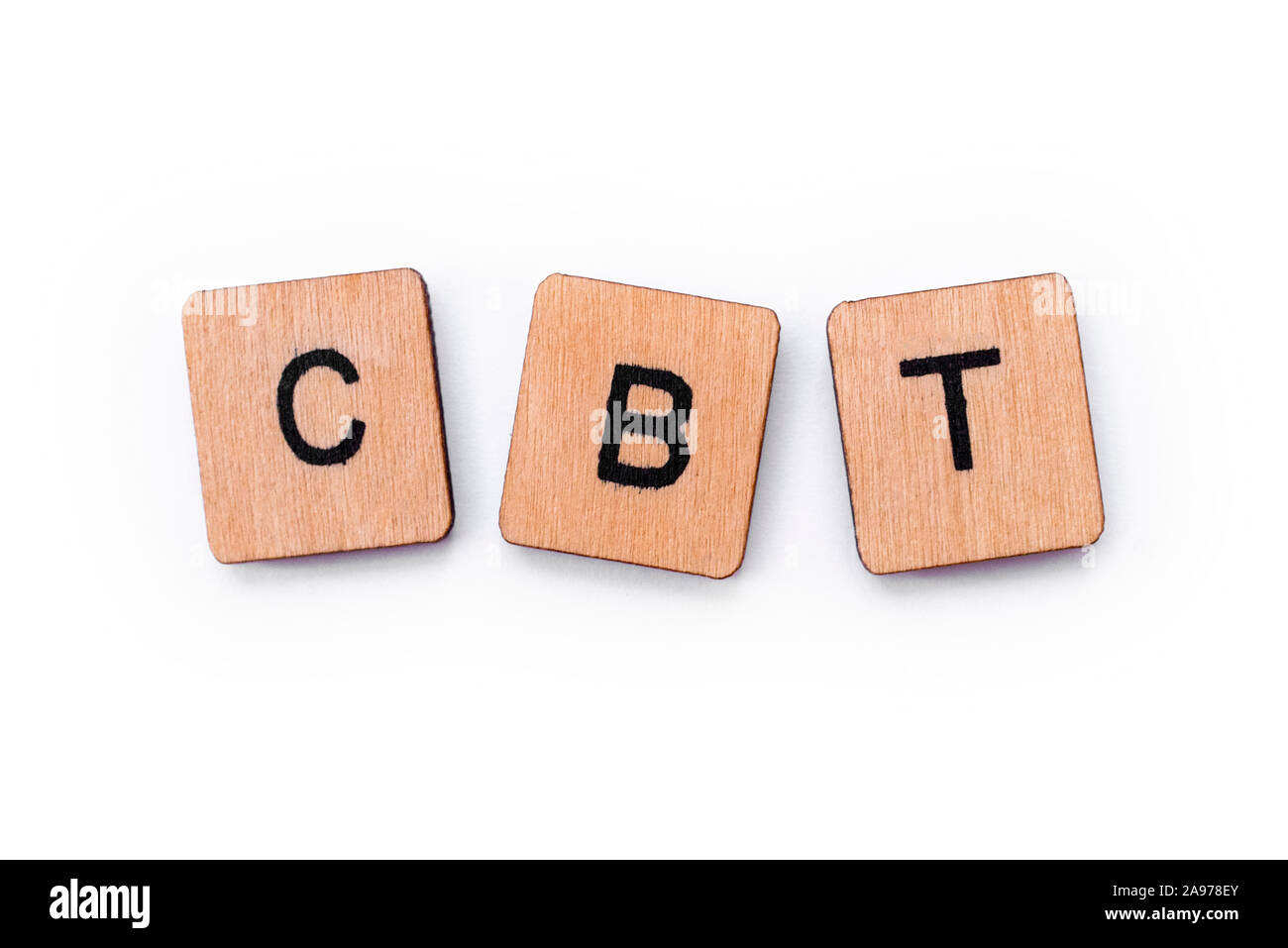 The abbreviation CBT - standing for Cognitive Behavioral Therapy, spelt with letter tiles over a white background. CBT is a psycho-social intervention Stock Photo