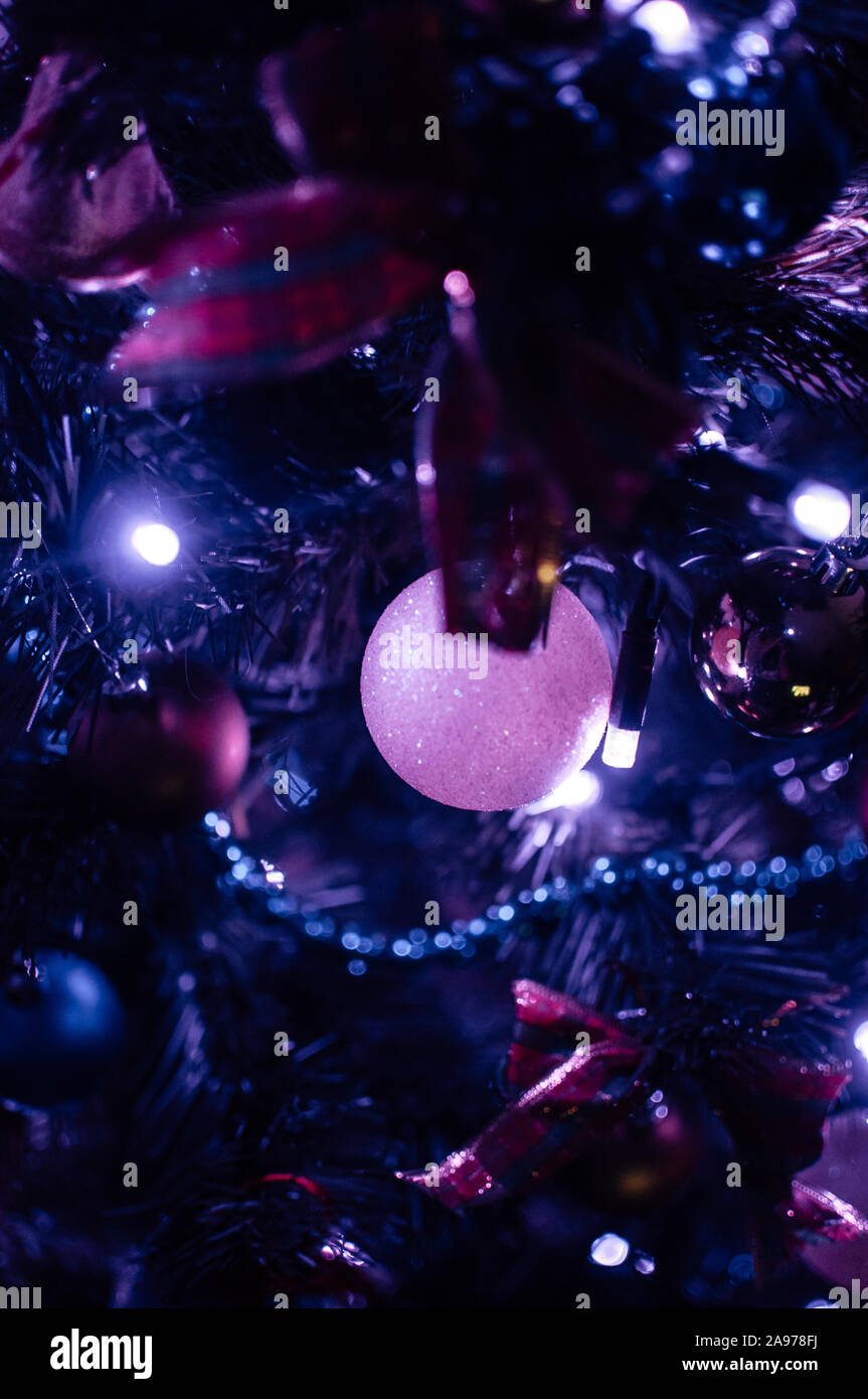 Decorated Christmas Tree Close Up In Neon Blue Light Toy Balls