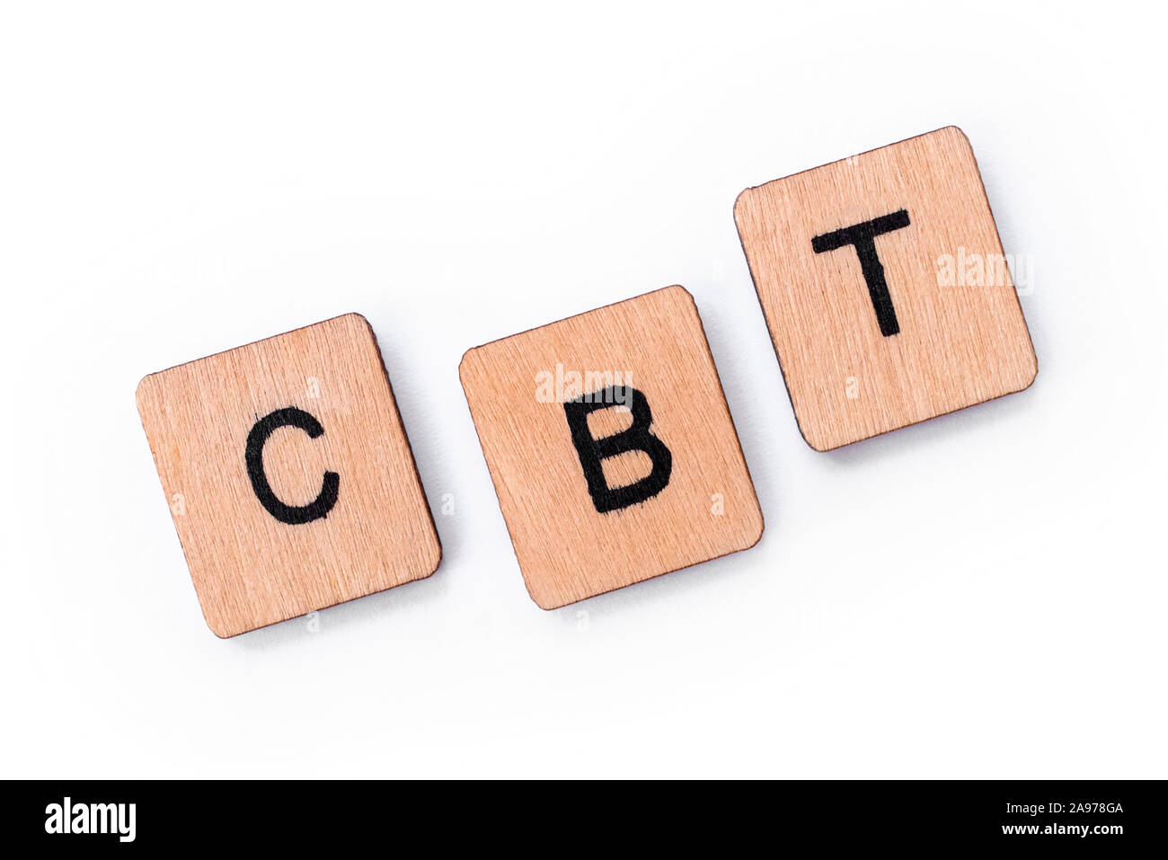 The abbreviation CBT - standing for Cognitive Behavioral Therapy, spelt with letter tiles over a white background. CBT is a psycho-social intervention Stock Photo