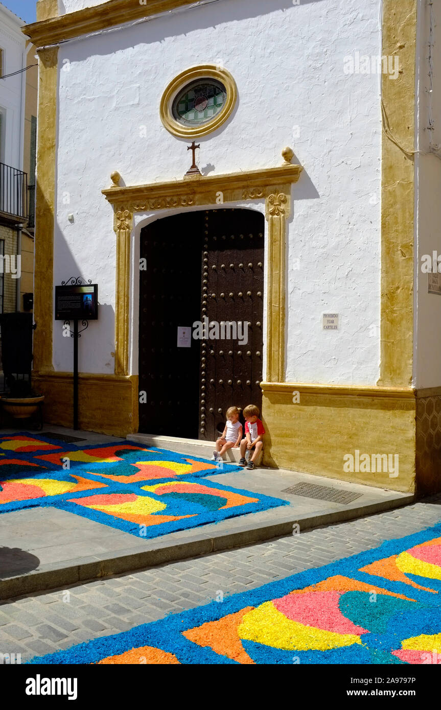 Colorful carpets of wood chippings in the village streets during Corpus Christi 2019, Carcabuey, Cordoba, Andalucia. Spain Stock Photo