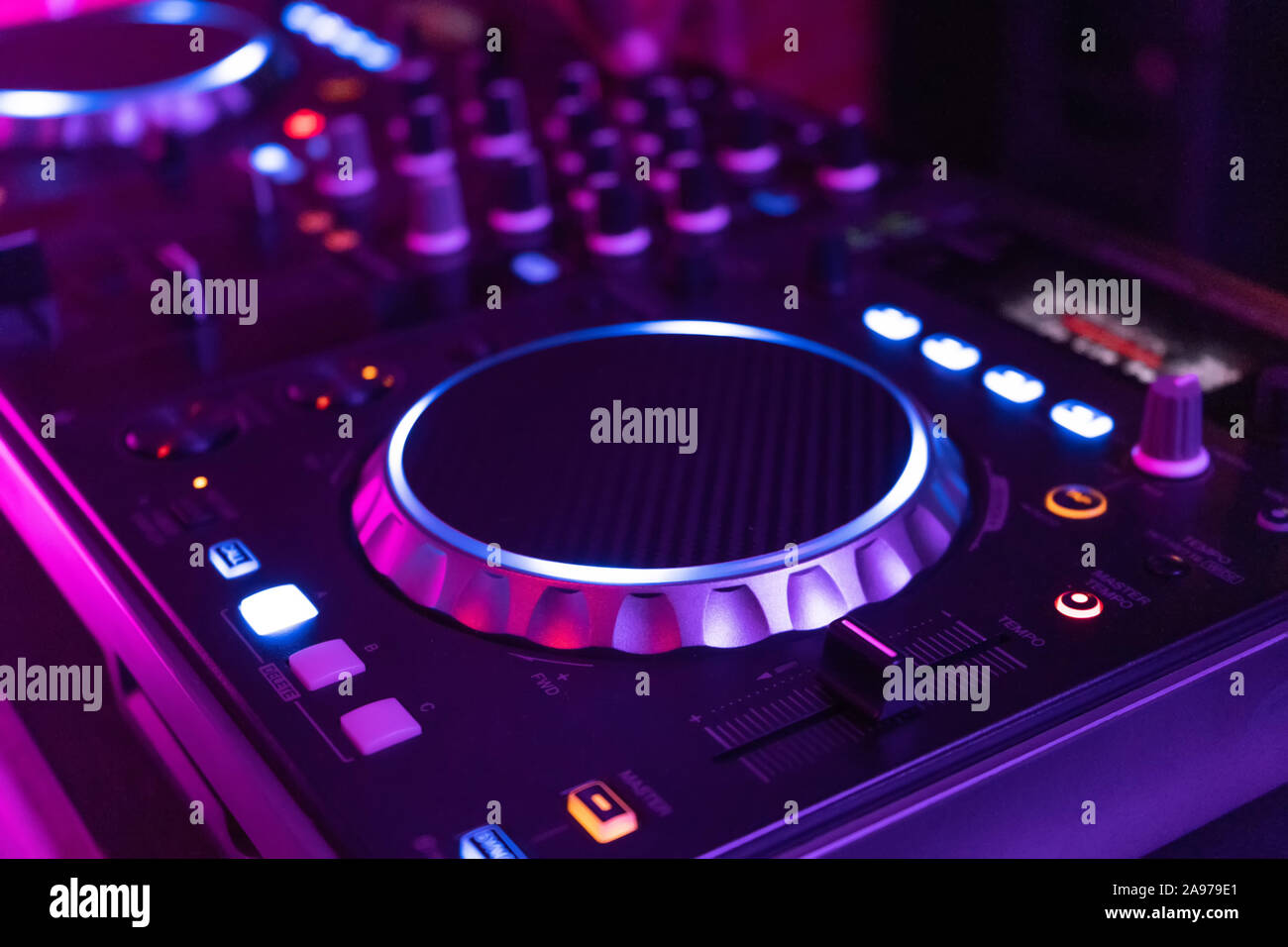 DJ playing music.Midi controller turntable.New digital technology for mixing audio tracks.Sound mixer with turntables.Disc jockey mix music at party Stock Photo