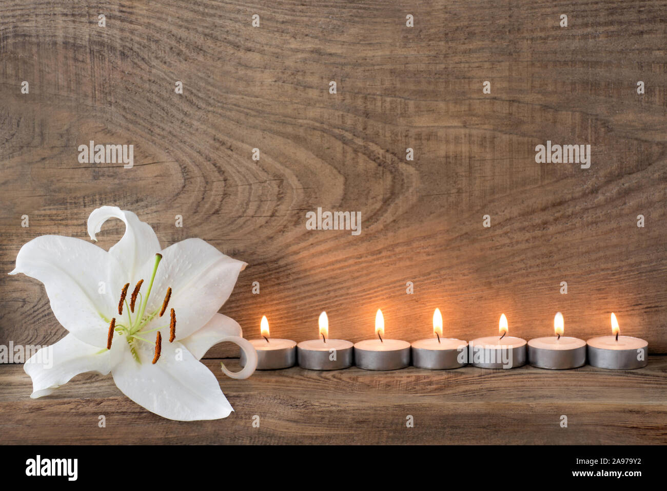 Lily and white candles Stock Photo