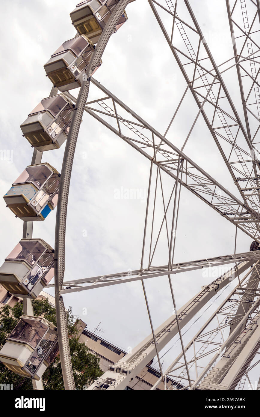 Fair ferris wheel in the central square of Budapest in a cloudy day. Stock Photo