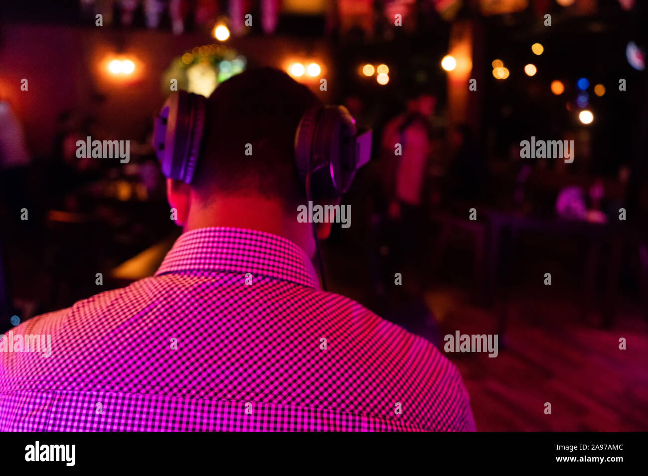the DJ behind work in night club Stock Photo