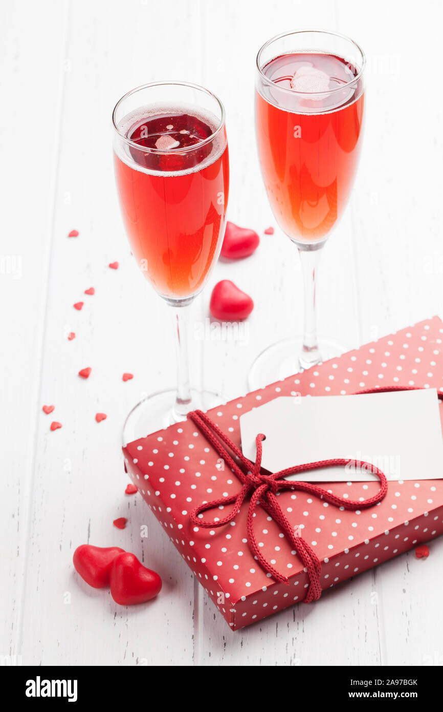 Valentine's day greeting card with rose champagne and gift box on ...