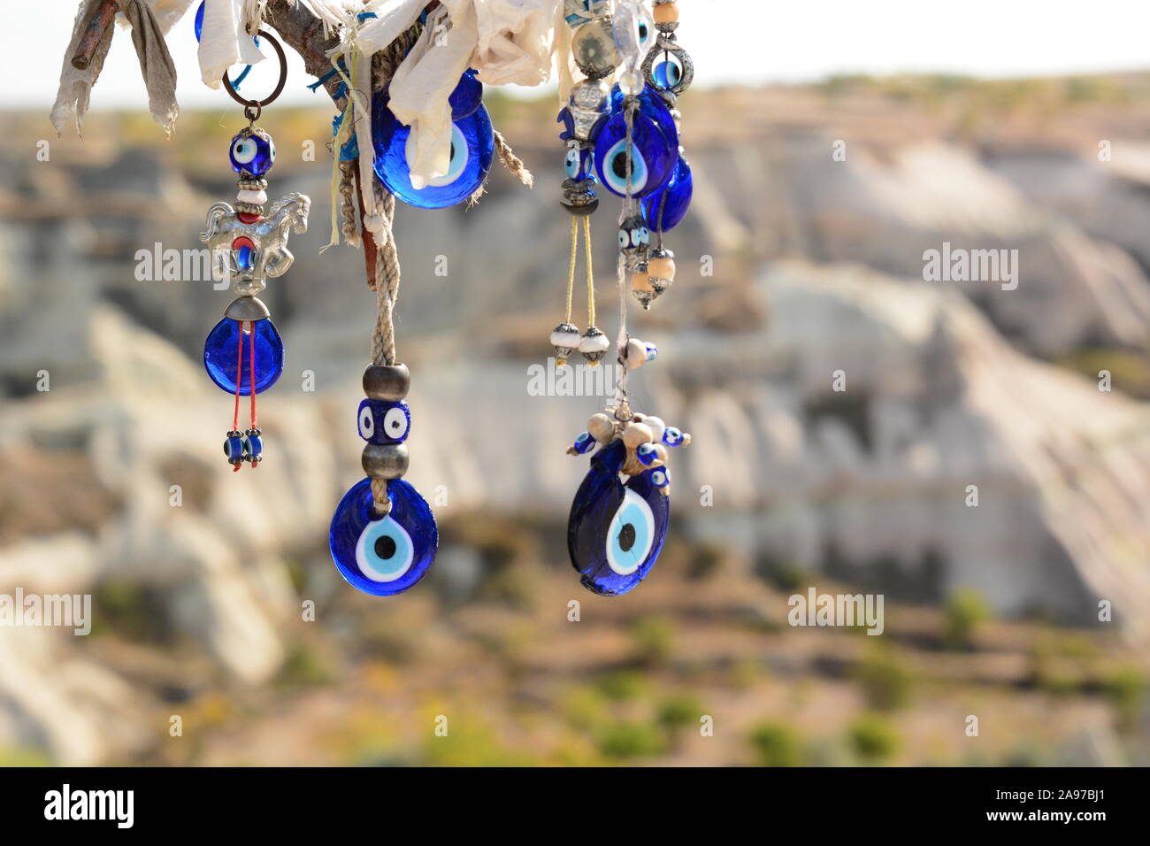 Nazars, traditional amulets, hanging from a tree. Goreme. Cappadocia. Turkey Stock Photo
