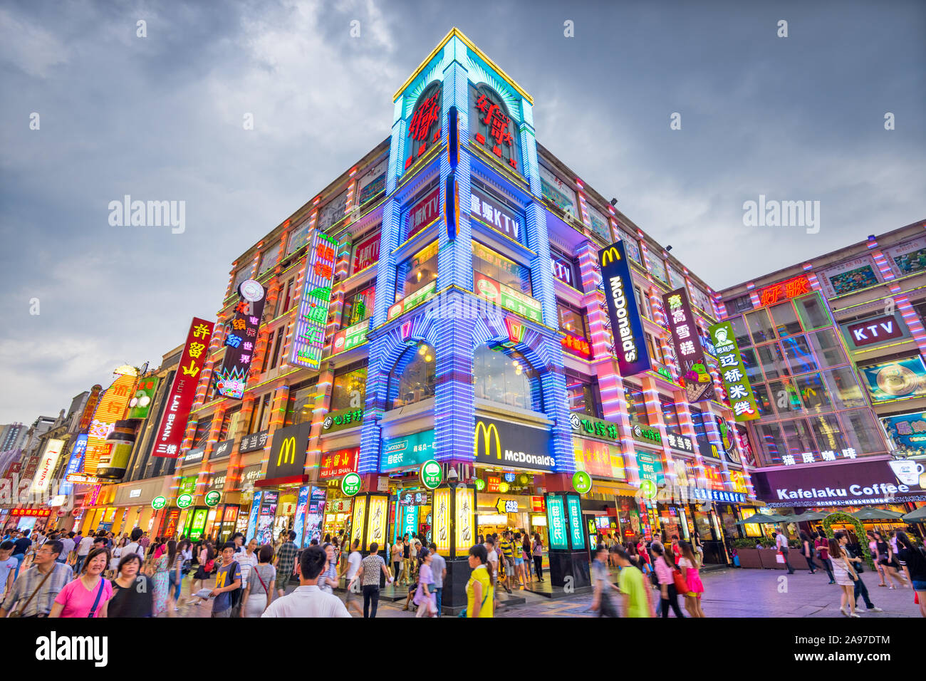 GUANGZHOU, CHINA - MAY 25, 2014: Pedestrians pass through Shangxiajiu Pedestrian Street. The street is the main shopping district of the city and a ma Stock Photo