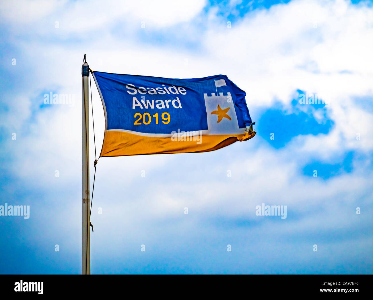 Beach award flag 2019 at Saltburn by the sea blown by a strong Northerly wind Stock Photo