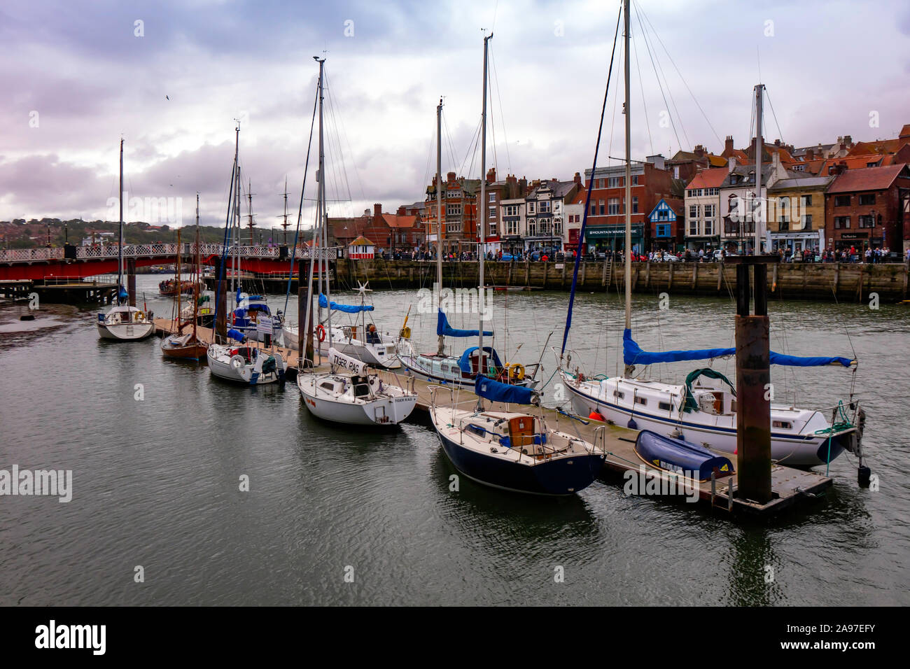 Pleasure craft moored in Whitby town centre harbour on the river Esk Stock Photo