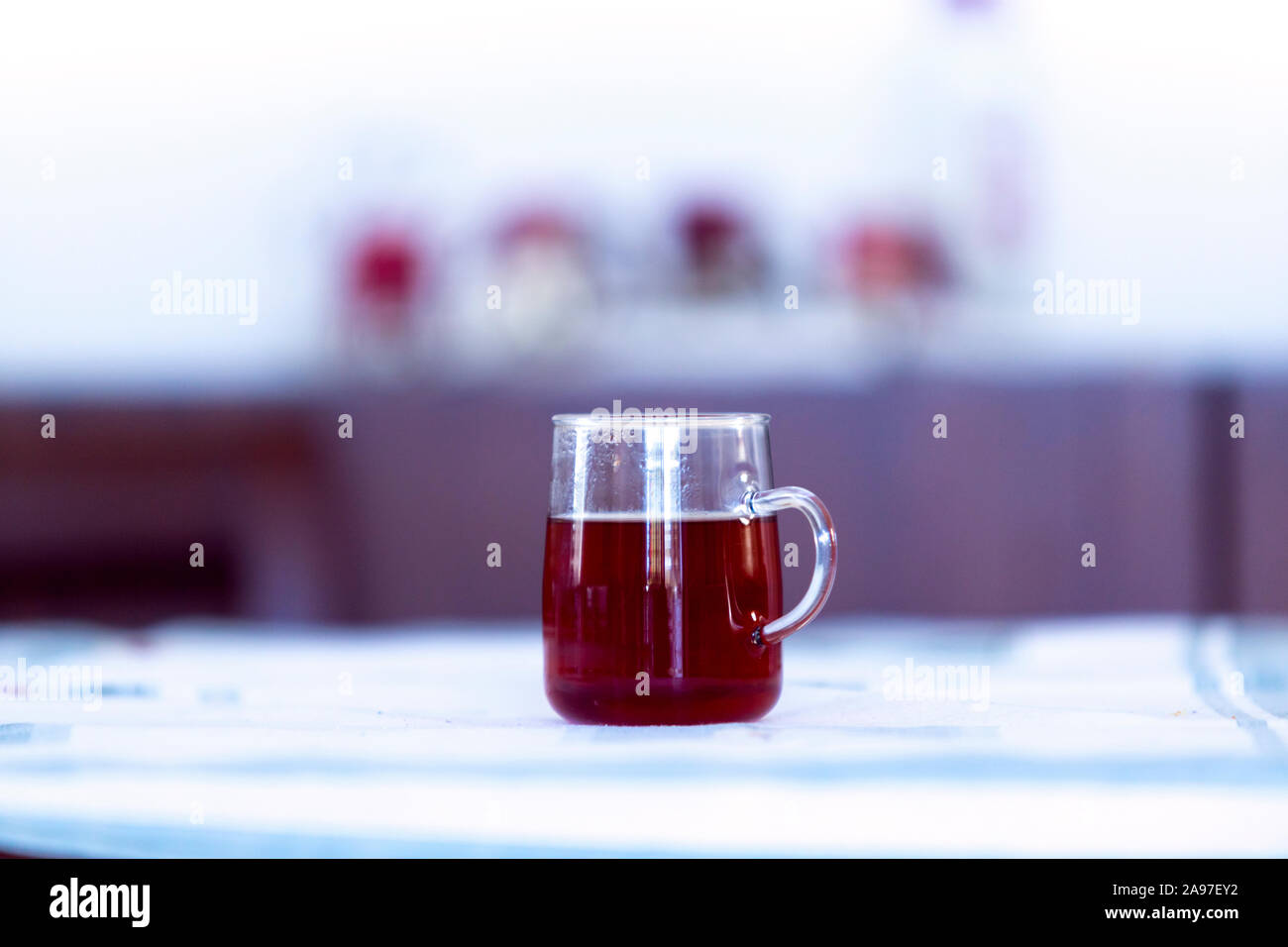 Close up of a glass cup of black tea in shallow depth of field image. Stock Photo