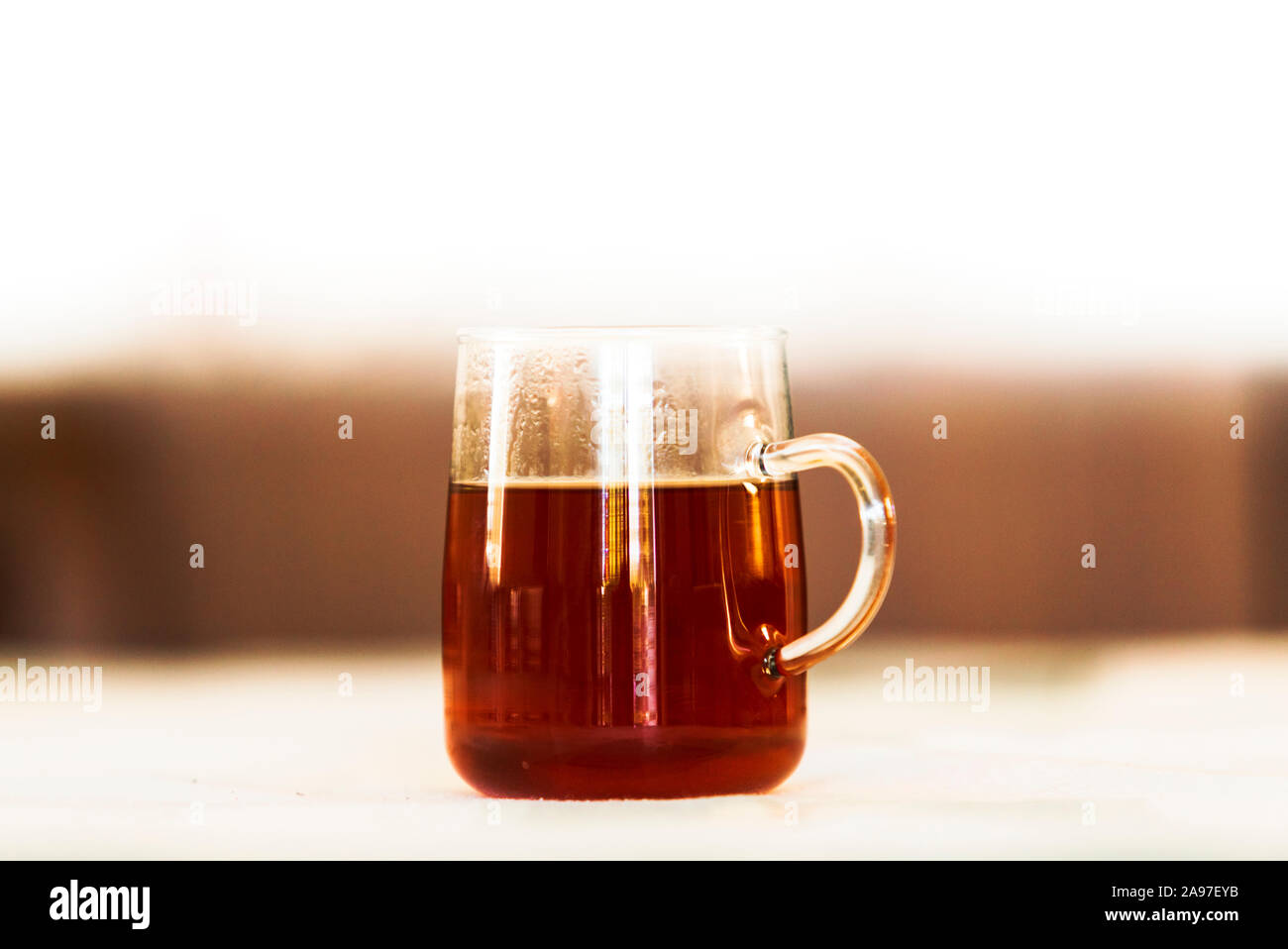 Close up of a glass cup of black tea in shallow depth of field image. Stock Photo