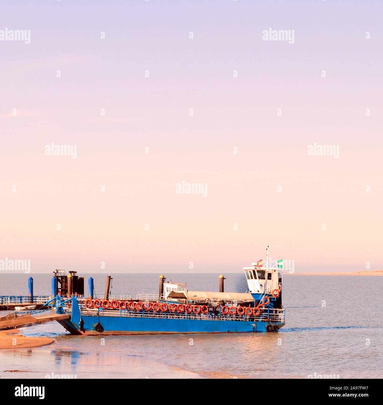 Boat moored at the pier of Sanlucar de Barrameda in Cadiz at the sunset Stock Photo