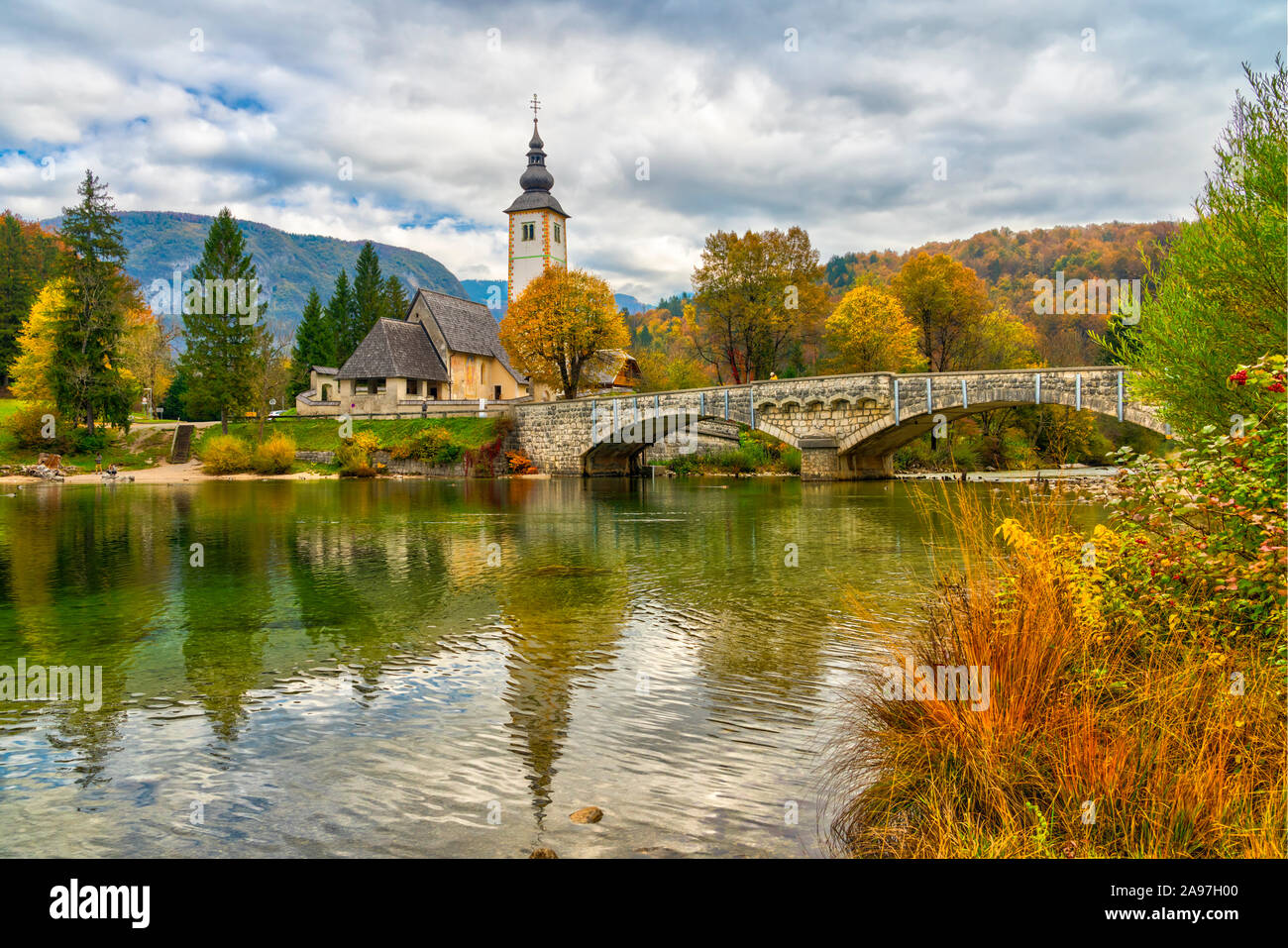 The Church of St John the Baptist reflected in Lake Bohinj, Slovenia ...
