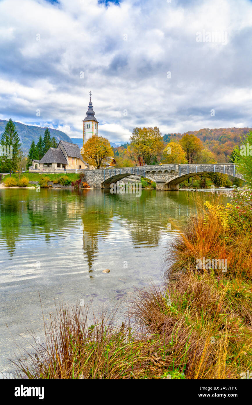 The Church of St John the Baptist reflected in Lake Bohinj, Slovenia ...