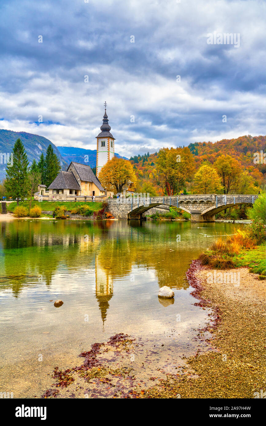 The Church of St John the Baptist reflected in Lake Bohinj, Slovenia