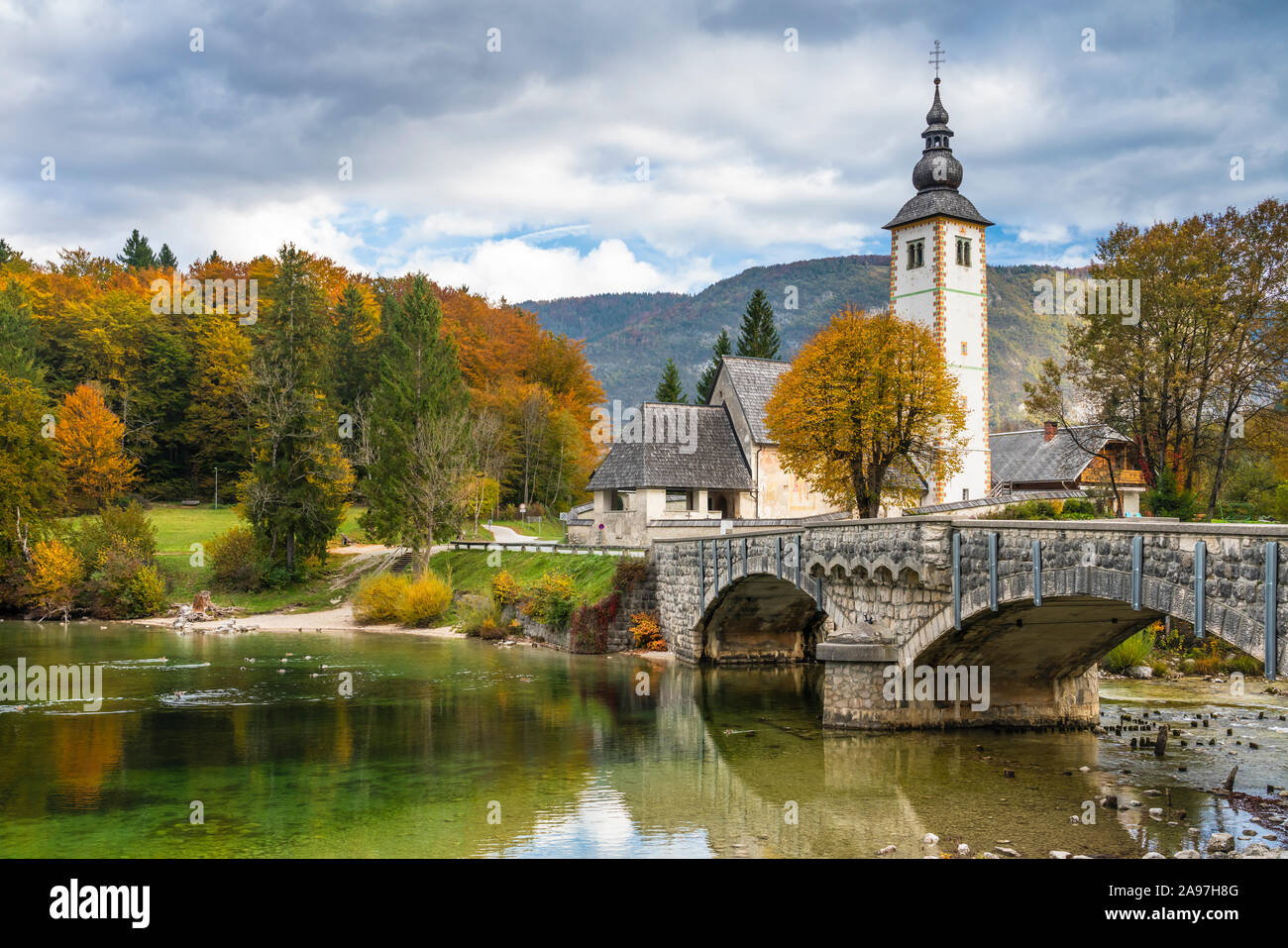 The Church of St John the Baptist reflected in Lake Bohinj, Slovenia ...
