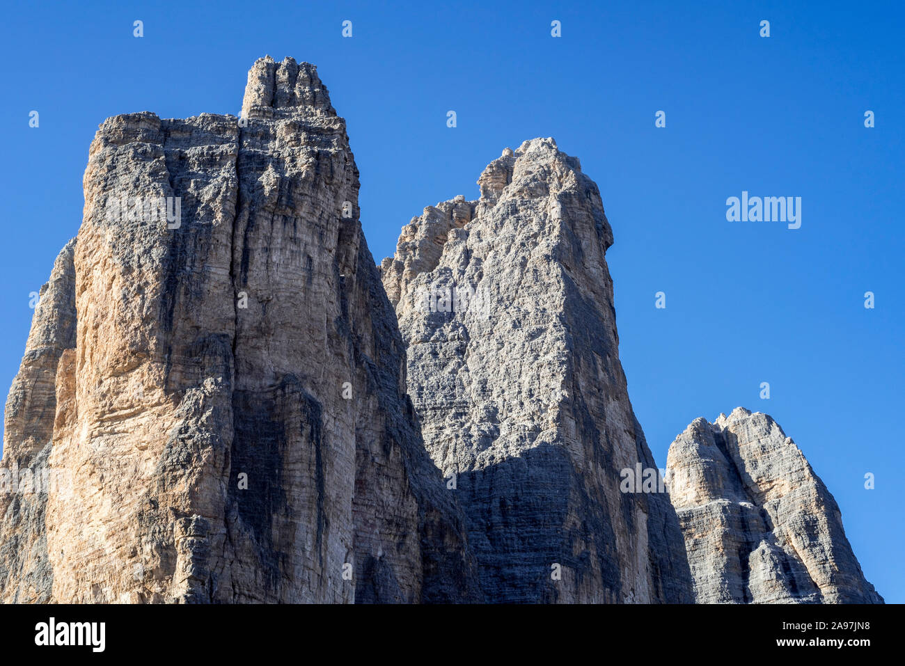 North face of the Tre Cime di Lavaredo / Drei Zinnen, three distinctive mountain peaks at sunrise in the Sesto / Sexten Dolomites, South Tyrol, Italy Stock Photo