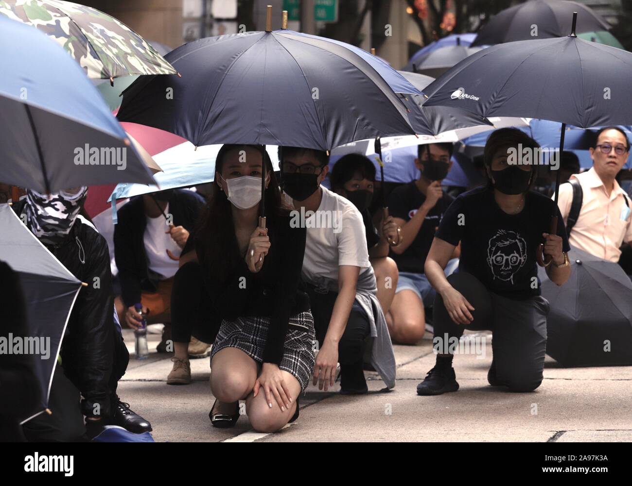 Hong Kong, China. 13th Nov, 2019. White Collars office workers staged a lunch hour flashmob protest for a 3rd day, blocking the main avenues confronting riot police with defiance in the financial hub in Central district. Credit: Liau Chung-ren/ZUMA Wire/Alamy Live News Stock Photo