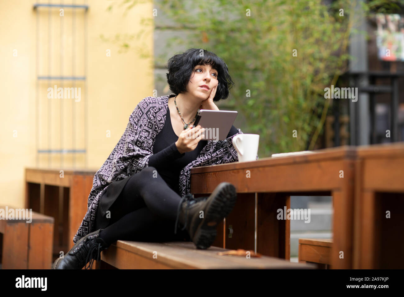 young woman with laptop outside working Stock Photo