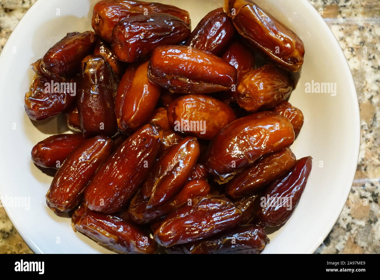Dried dates in a bowl Stock Photo