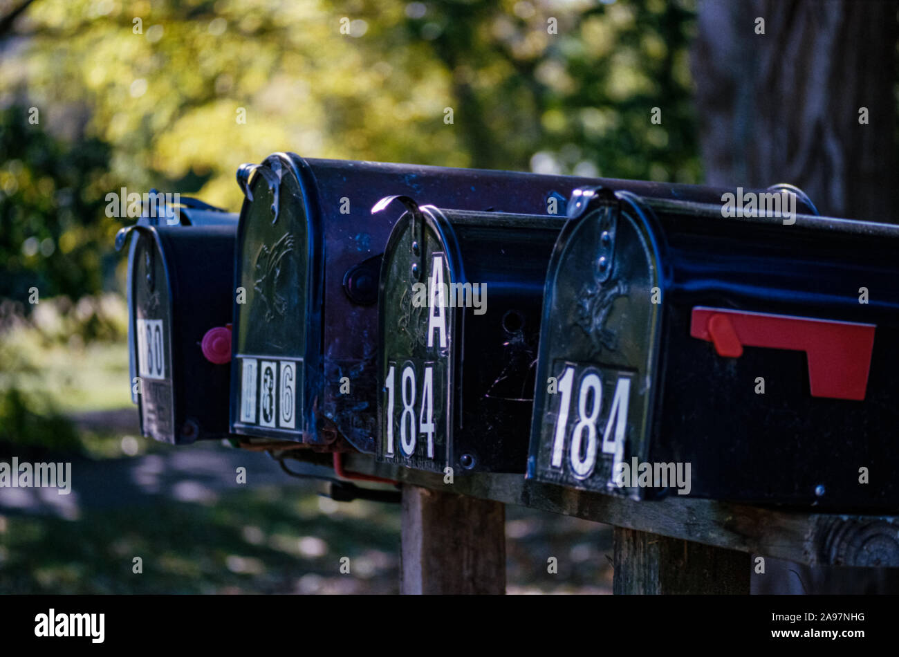 Four Mailboxes in a Row with Numbers and a Red Flag Stock Photo Alamy