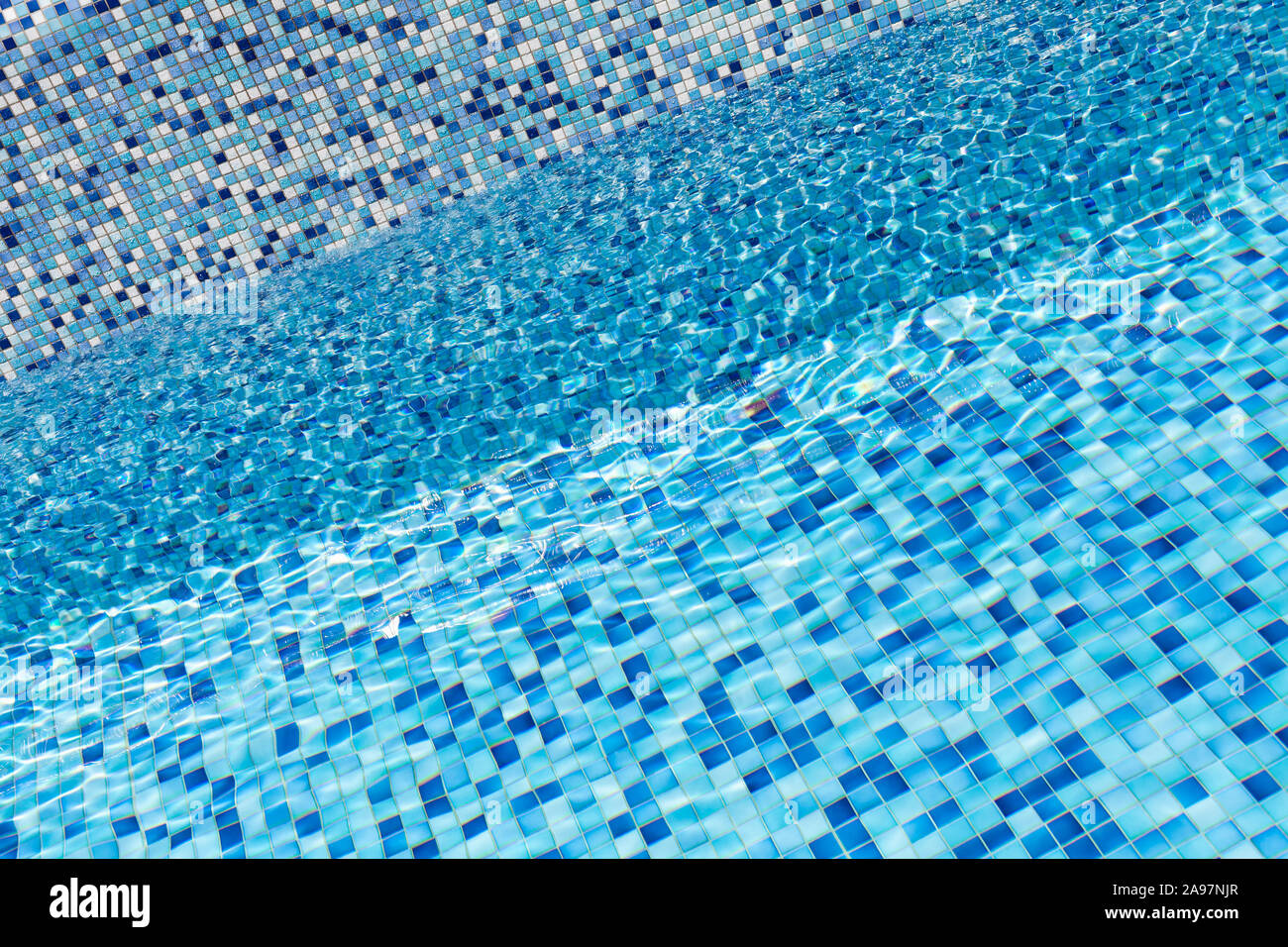 Empty pool, blue water and mosaic tiling, background photo texture Stock Photo