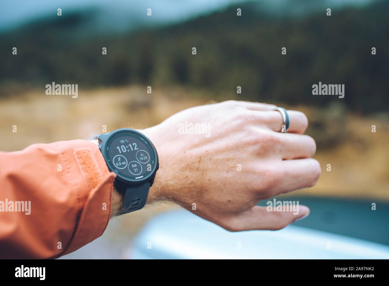 A Caucasian male holds out his wrist to check the time on a watch Stock Photo