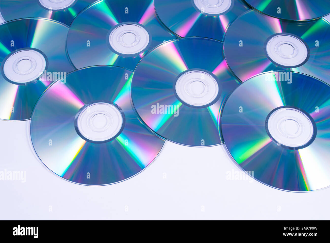 A shot of shiny Compact Discs or CDs, over a white background. Stock Photo