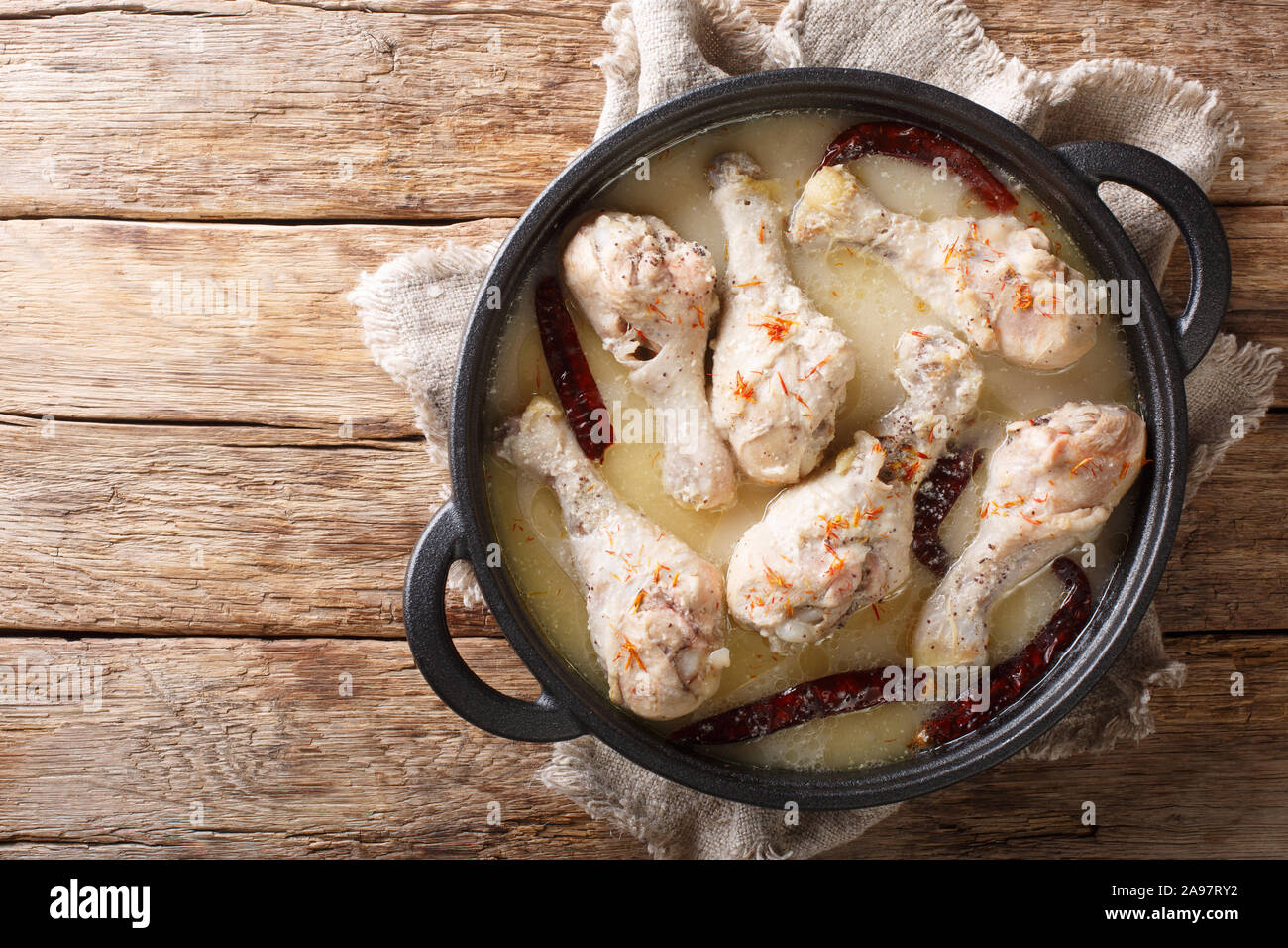 Traditional bengali chicken rezala in white curry sauce with chili