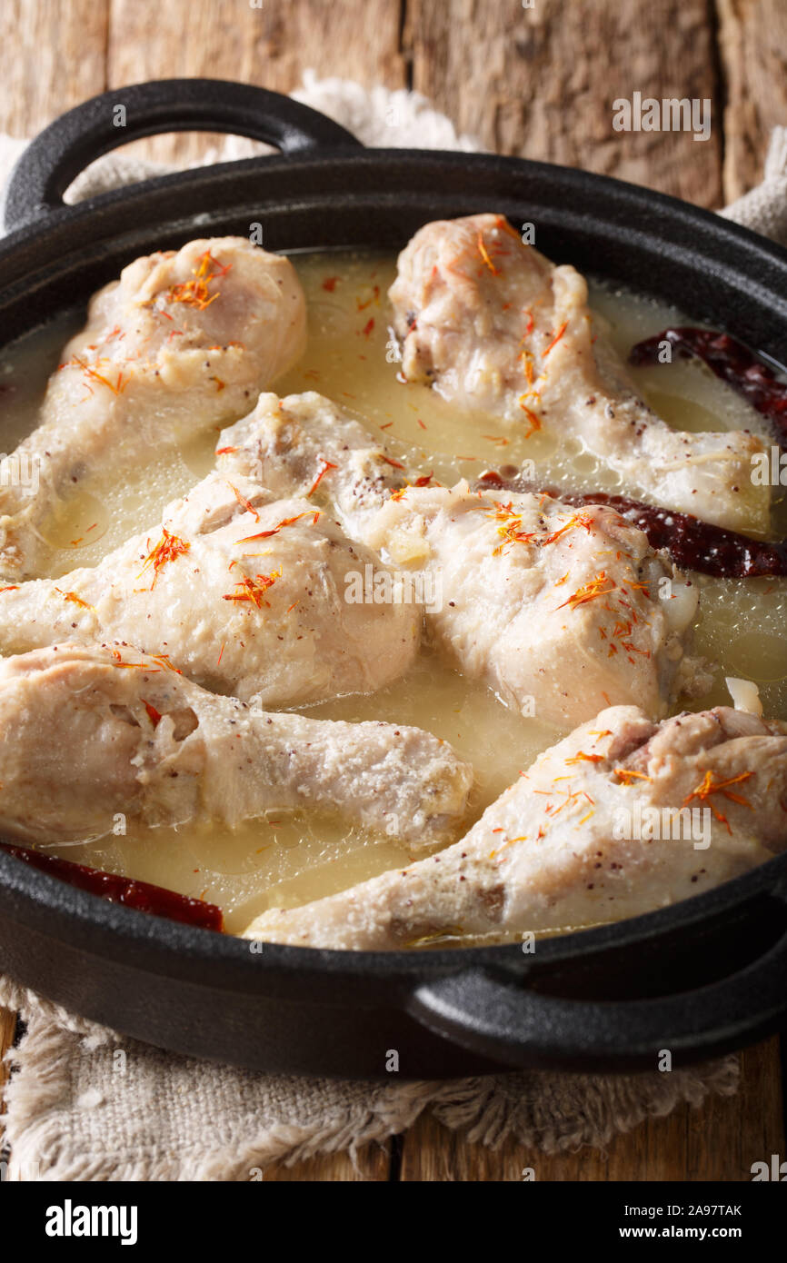 Chicken Rezala is a traditional East Indian dish especially prepared for special occasions close-up on a plate on the table. Vertical Stock Photo