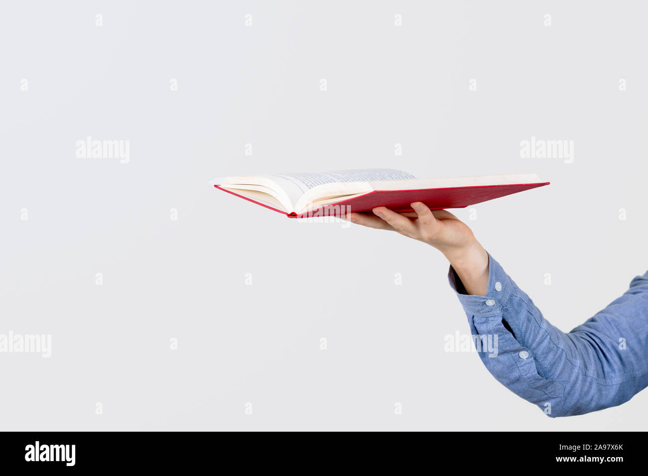 Teenager hand holding a open book isolated on a white background Stock