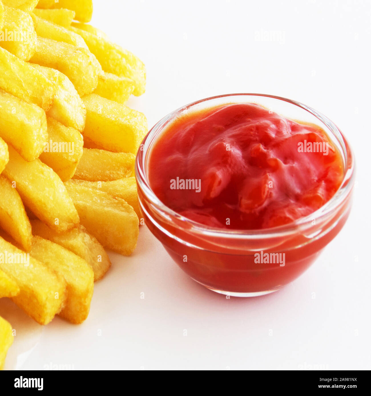 Potato chips and tomato sauce on white background Stock Photo Alamy
