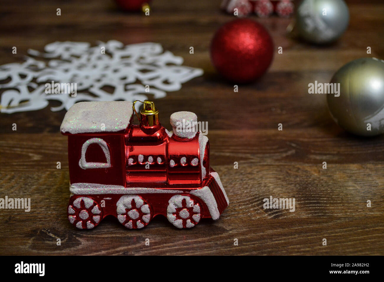 Red train and paper snow flake as Christmas ornaments decorations, photo-illustration Stock Photo