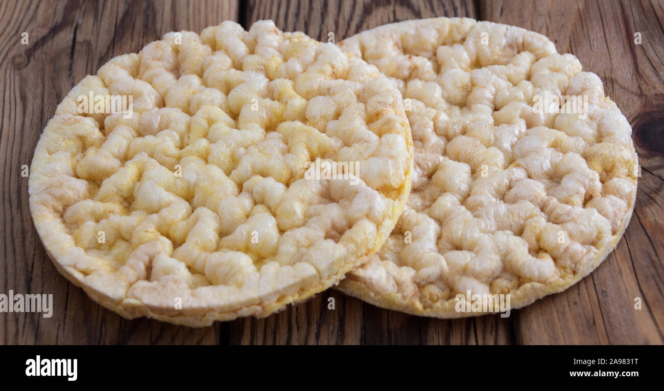 Crunchy corn cakes against wooden background Stock Photo