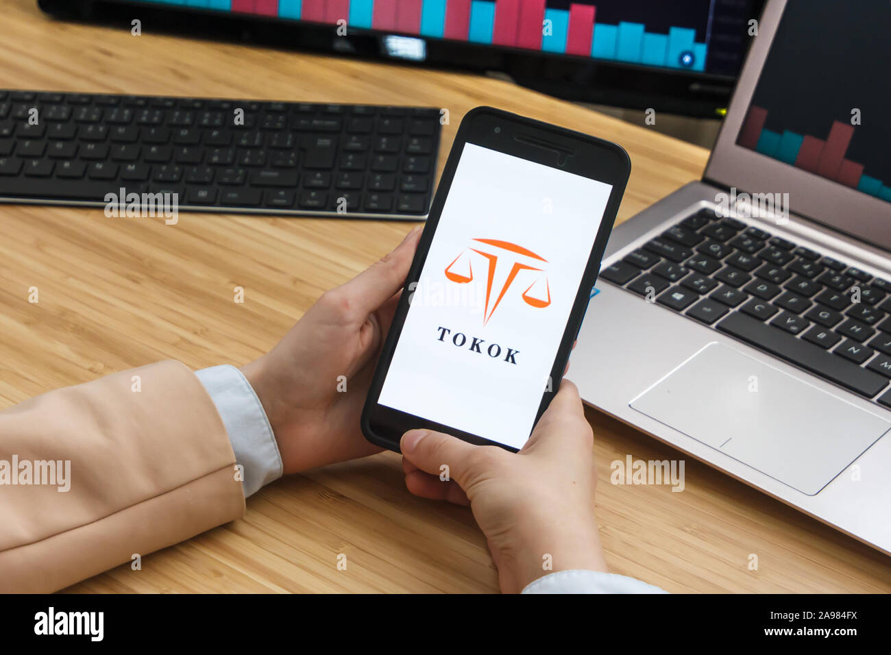 Tokok Cryptocurrency Exchange Market. Female Trader Hands Holding the  Smartphone Using Application. Crypto Background Concept, San Francisco  Stock Photo - Alamy