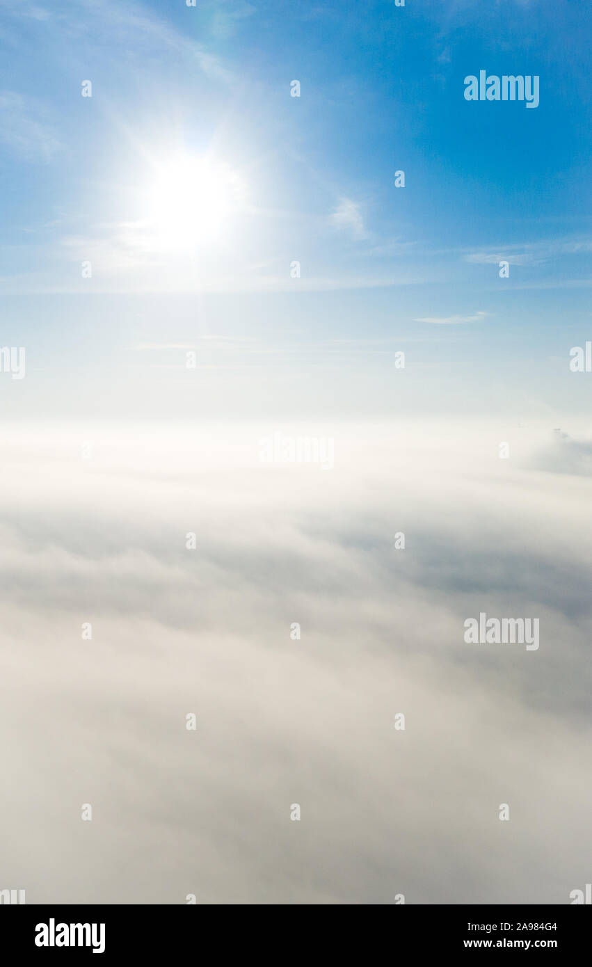 Aerial photo above the fog or white clouds with shining sun. Beautiful ...