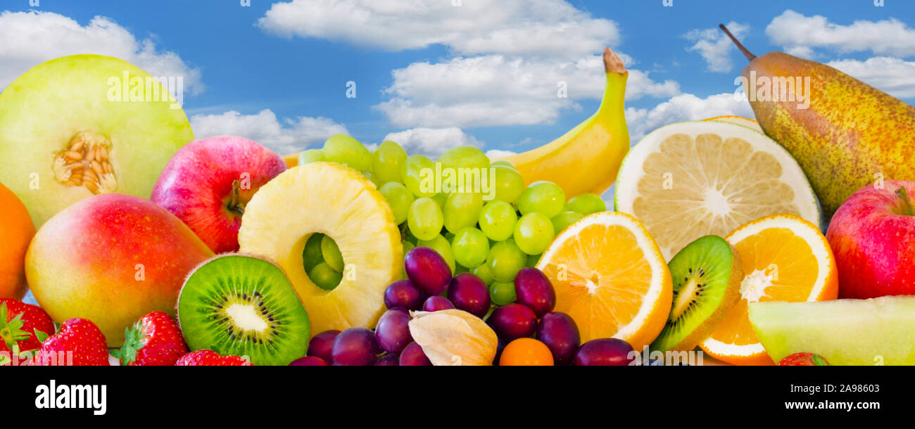 Selection of fruits against blue sky Stock Photo