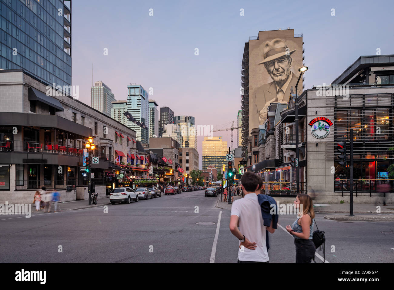Illuminated Leonard Cohen mural on Crescent Street viewed from De