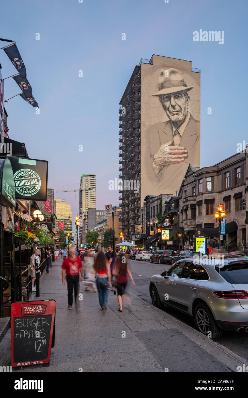 Illuminated Leonard Cohen mural on Crescent Street viewed from De
