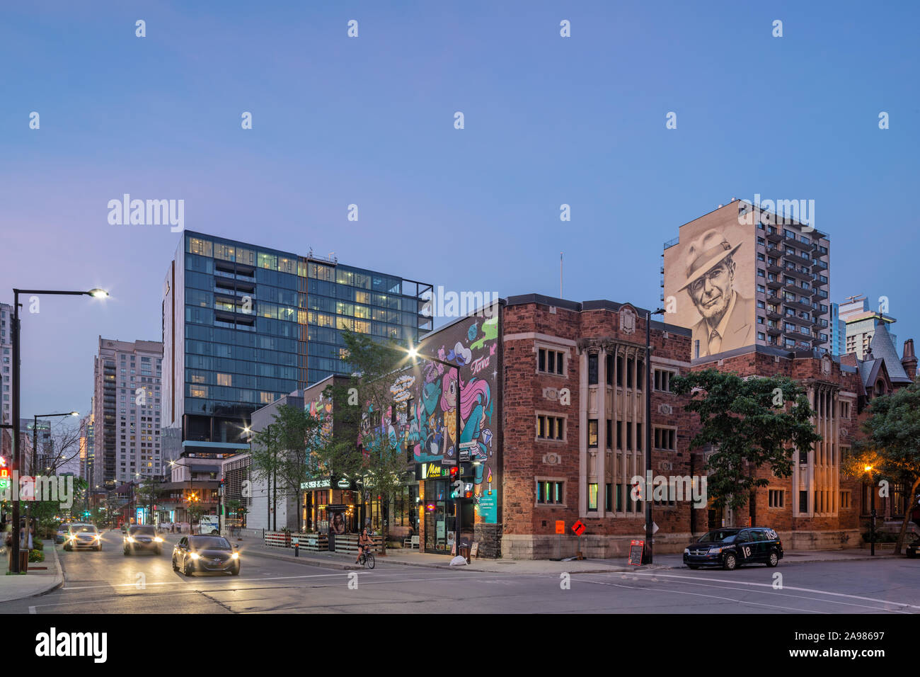 Antoine Tava and Leonard Cohen mural at dusk, De Maisonneuve boulevard
