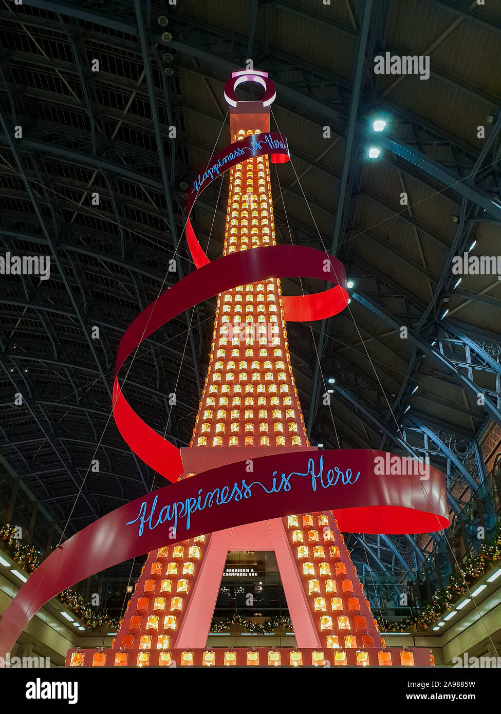 Kings Cross St Pancras. London. UK 13 Nov 2019 - “The Eiffel Tower” installation at Kings Cross St Pancras International rail station. Lancome has teamed up with Kings Cross St Pancras as it unveils its 2019 Christmas installation of Paris’s iconic landmark - The Eiffel Tower. The 36-foot installation embodies the elegance and cheerful spirit of the world’s largest French beauty brand, brightening up the station with Lancôme’s signature pink pantone. Credit: Dinendra Haria/Alamy Live News Stock Photo